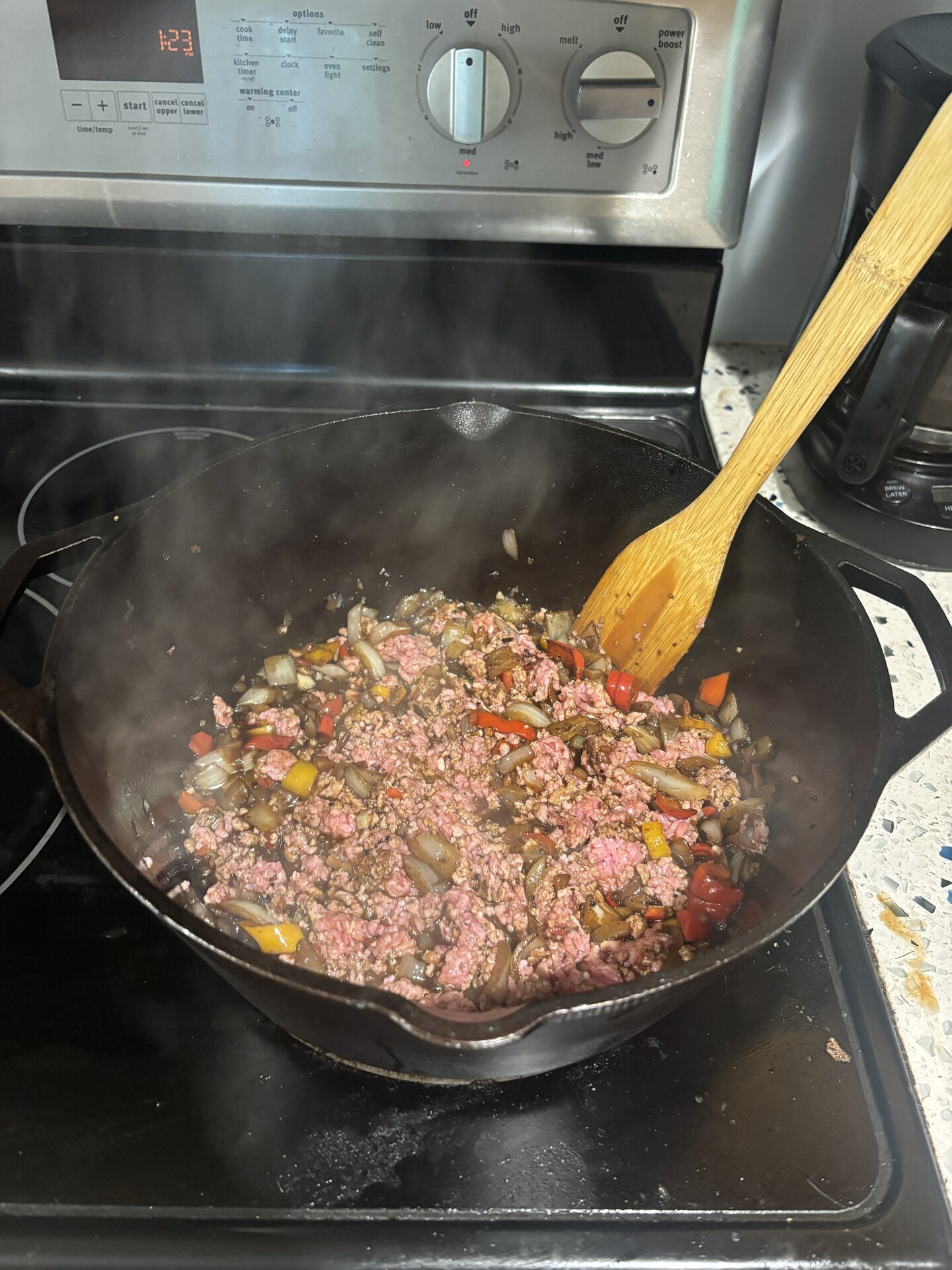 Peppers and minced garlic added to the onions
